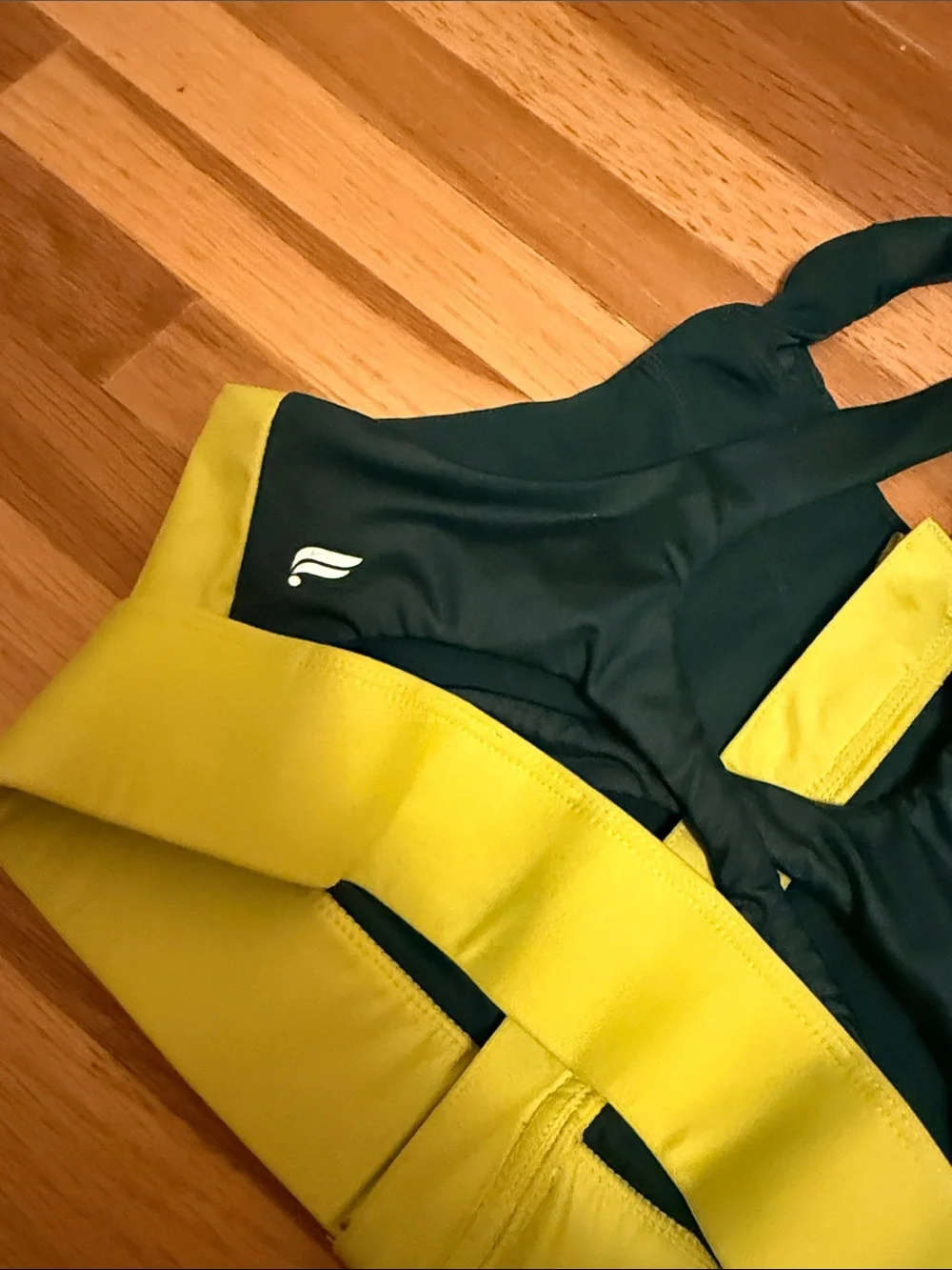 Fabletics Two-Tone Front-Zip Sports Bra in Black and Mustard